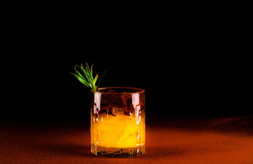 Quarantini or homemade alcohol drink in a glass beaker on terracotta background. The concept of new popular drinks. Close-up