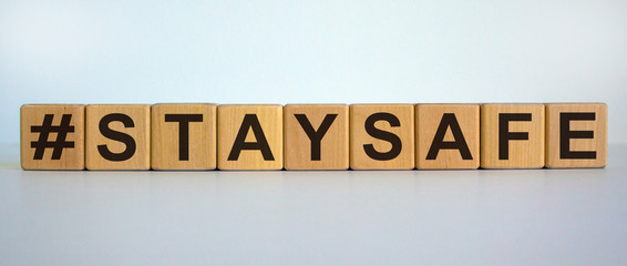 Wooden cubes form the words 'staysafe'. Beautiful white background.