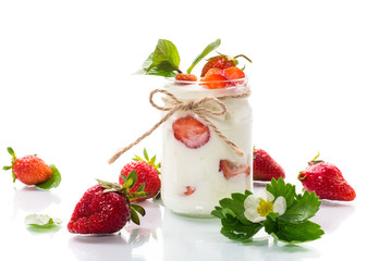 sweet homemade yogurt with ripe fresh strawberries in a jar