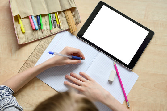 Online home lesson. Blank for your text. Children's hands in the frame. School supplies. Social distance.