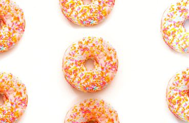 Berry donut with colorful sprinkles on white background. National Donut or Doughnut day concept. Close-up