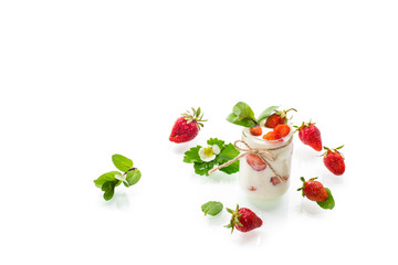 sweet homemade yogurt with ripe fresh strawberries in a jar