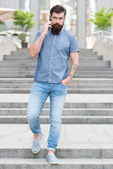 Fototapeta premium Got it. Business conversation. Man with smartphone. Stylish handsome man with bristle outdoors. Man wearing casual shirt hold smartphone. Agile business. Modern life. Call taxi. Mobile communication