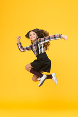 Free style. Happy schoolchild in midair yellow background. Free from school. Summer holidays. Free time. All good things are wild and free