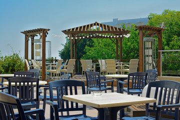 Tables in an open-air cafe in the resort with views of tropical vegetation