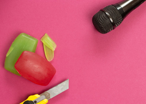 ASMR concept. Specific auditory irritants. Soap and a knife lie in front of the microphone. Top view, flat lay.
