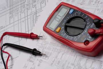 Top view, multimeter on electronic diagram. electronic repairs concept. technical assistance topic. maintenance services, electrical and electronic system designs