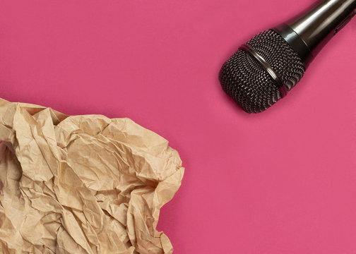 ASMR concept. Specific auditory irritants. Wrinkled paper lie in front of the microphone. Top view, flat lay.