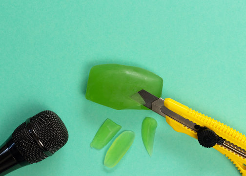 ASMR concept. Specific auditory irritants. Soap and a knife lie in front of the microphone. Top view, flat lay.