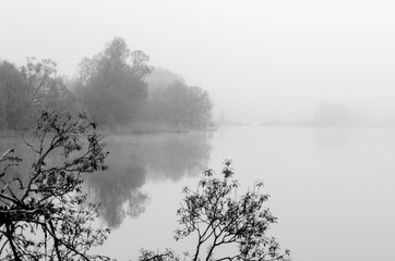 Fog on the lake, cloudy morning, poor visibility and high humidity.