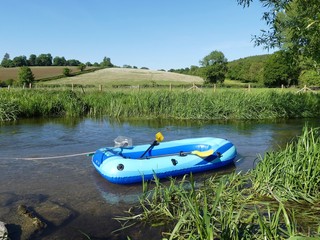 Children's inflatable dinghy in the River Chess at Chorleywood, Hertfordshire