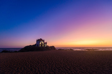 Obraz premium Tourism trip to Portugal, Porto, famous for the Capela do Senhora Pedra. Amazing cliff rocks on the Atlantic ocean west coast of Portugal in Alentejo region at sunset