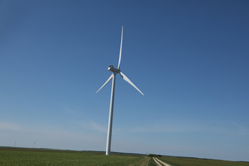 Fototapeta premium Windmill for electric power production, France. Blue sky