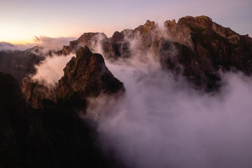 Beautiful cloudy mountains sunset view, clouds above mountain peaks with bright sky background