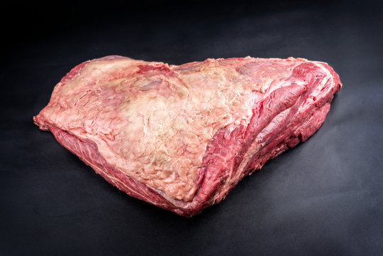Raw dry aged wagyu beef shoulder clod roast as closeup on black background with copy space