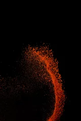 Deurstickers Red paprika spices powder explosion, flying chili pepper isolated on black background. Splash of spice background. © PINKASEVICH