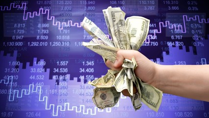 Dollar banknotes in human hand on stocks background