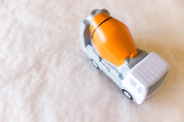 layout of concrete truck mixer on rough white-grey background. Free copy space. Delivery of ready...