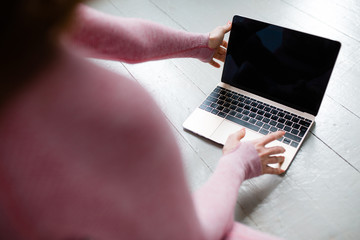 Close-up of a laptop screen with a black screen for inserting an image and a girl switching a video tutorial