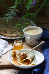 Nettle and spinach pancakes served with honey and coffee. Rustic style.