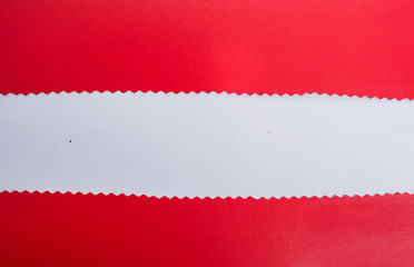 Red unevenly cut paper on a white background with space for text.