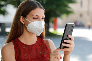 COVID-19 Close Up Young Woman Wearing KN95 FFP2 Mask Using Smart Phone App in City Street to Aid...