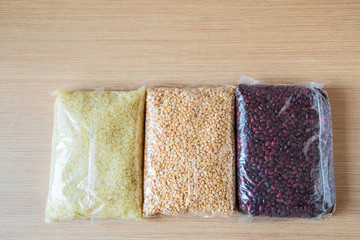 a set of delivery products, cereals and a tin can, on a wooden table