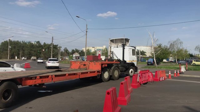 Road repair at intersection, detours, road signs and blocks, cars drive around