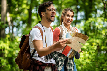 Man and woman looking at a map and laughing