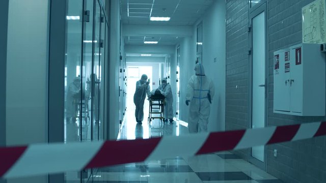 Paramedics are transporting a patient through the hospital during coronavirus pandemic.