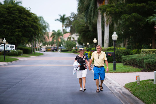 Senior Couple walking hand in hand enjoying retirement
