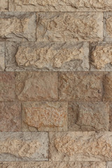 Fototapeta premium Wall made of yellow natural stone vertical view 2