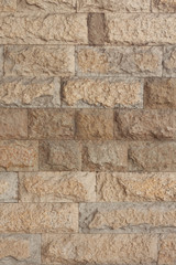 Wall made of yellow natural stone vertical view