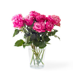 Obraz premium Bouquet of red roses in a glass vase on a white background.