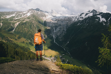 Man hiker standing on a hilltop in the French Alps, Le Tour, France