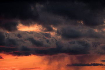 large dark clouds at sunset in spring