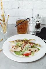 Fresh caesar salad with chicken breast and tomatoes