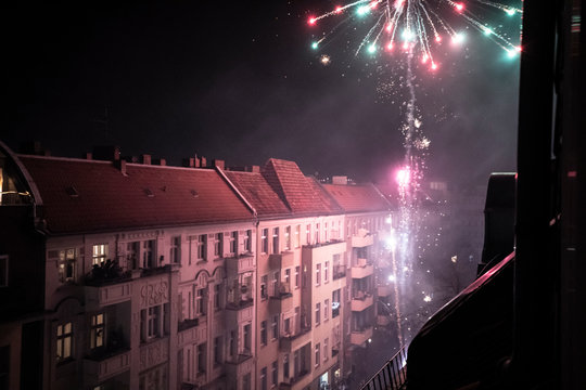 Home fireworks explode from balcony high in Berlin streets new year