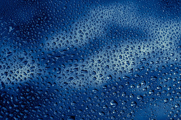 blue water drops on the glass close up