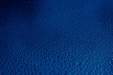 blue water drops on the glass close up