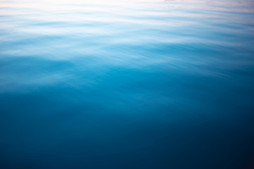 Blue water surface. Deep blue water background. Beautiful background, space for text.