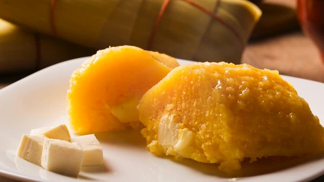 Slide shot Pamonha with cheese - typical food of green corn - tasty and cheap - typical and popular street food with smoke.