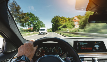 hands of car driver on steering wheel, road trip, driving on highway road