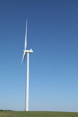 Windmill for electric power production, France. Blue sky