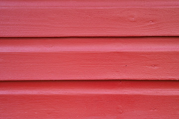 Red painted wooden wall of a cabin