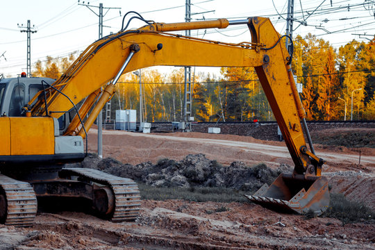 close-up of an excavator that is carrying out repair work near the railway tracks. the construction of new roads