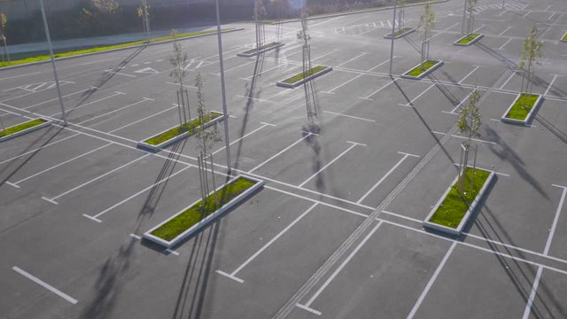 Aerial tracking shot of an empty parking lot