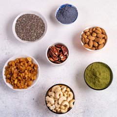 Top view collection of Superfoods and nuts in Bowls for health, fitness and vitality used for preparing energy balls.