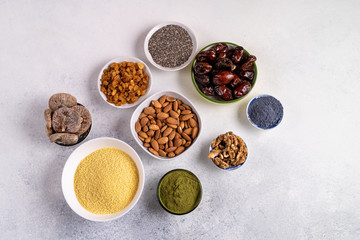 Top view collection of Superfoods and nuts in Bowls for health, fitness and vitality used for preparing energy balls.