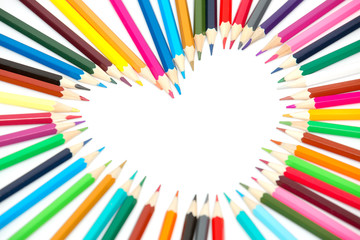 Colorful pencils in the shape of a heart isolated on white background .Selective focus.Copy space